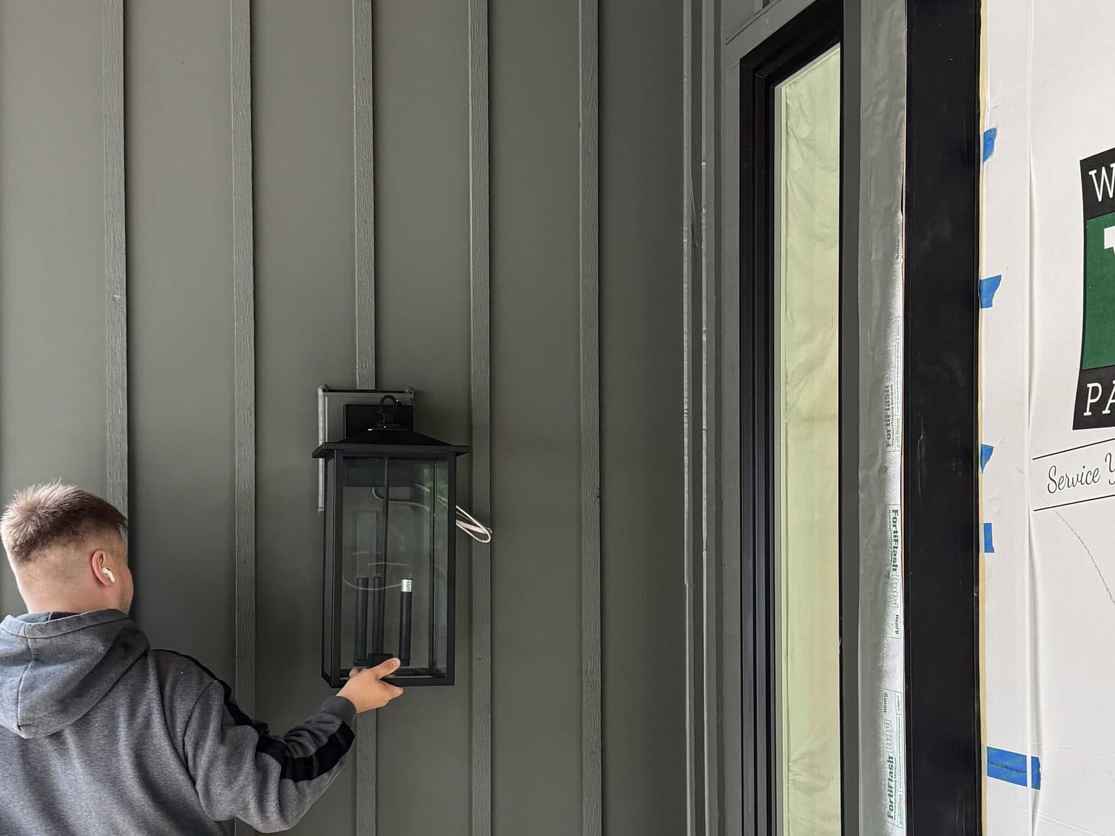 Mad Dog Electric electrician mounting an exterior lantern fixture