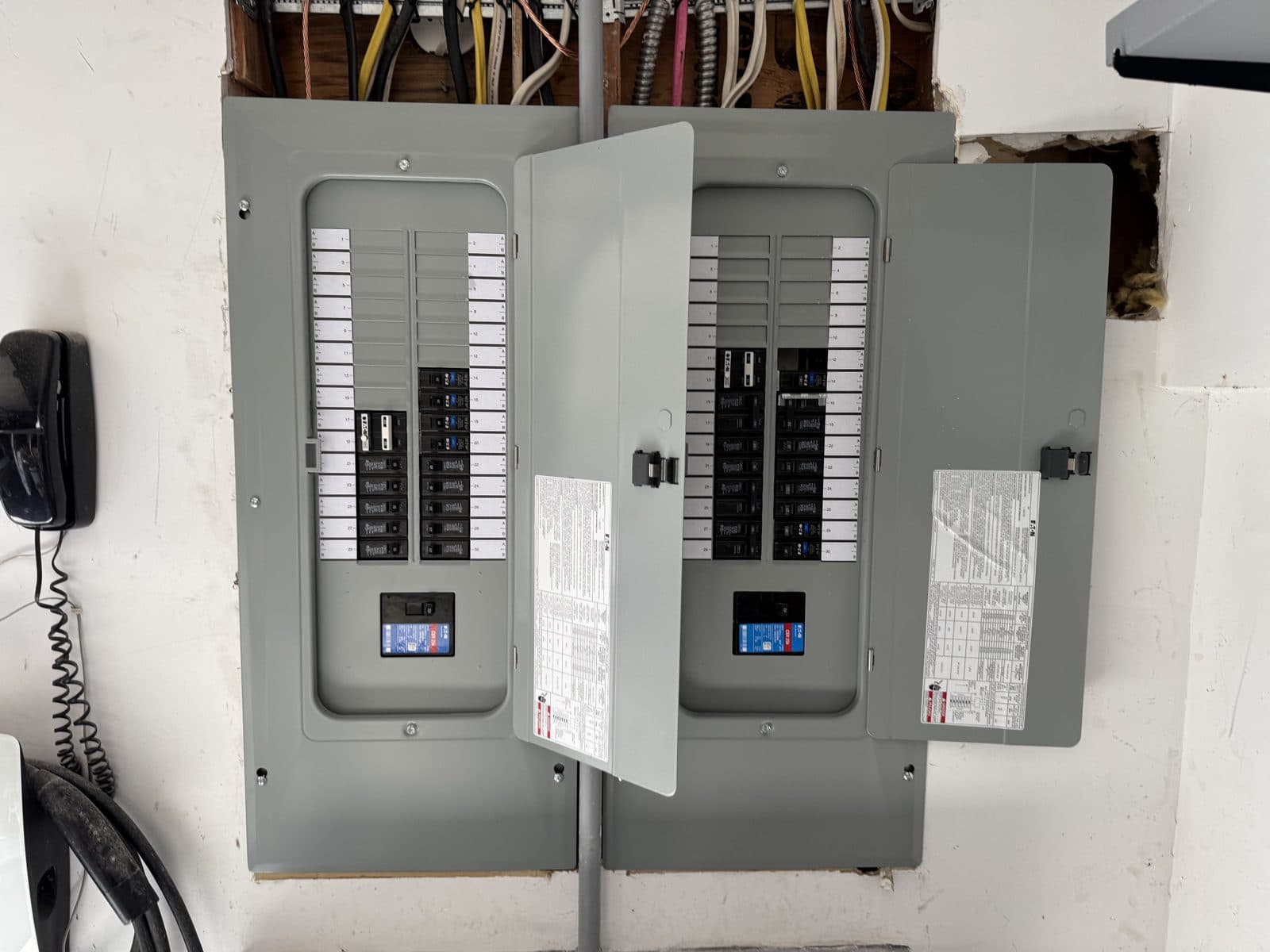 Twin electrical panels installed by Mad Dog Electric